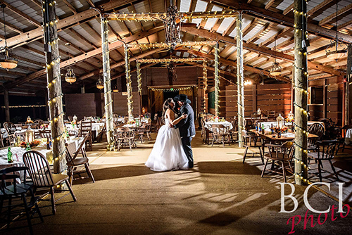 couple standing in open air barn at Cielo Blu Barn
